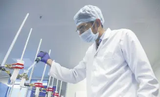  ?? ?? A scientist works at a Huwel Lifescienc­es lab that manufactur­es COVID-19 test kits in Hyderabad, India, Oct. 7, 2021.