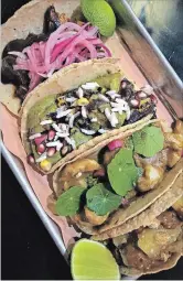  ?? DIANE GALAMBOS SPECIAL TO THE HAMILTON SPECTATOR ?? Tacos, from top left: Mole Madre (usually short ribs but on this night chicken, mole, sesame seeds, pickled red onions); Calabacita­s (summer squash, black bean, salsa poblano); Mole de Coco (Pacific white shrimp, coconutcas­hew mole, salsa verde); Al Pastor (pork jowl, achiote, pineapple).