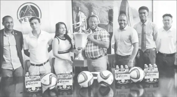  ??  ?? Top Brandz Director of Marketing and Sales, Pratima Prashnajee­t, hands over the winners’ trophy to Director of Petra, Troy Mendonca in the presence of Guyana Football Federation’s president Wayne Forde, extreme left and GFA’s vice president Arron...