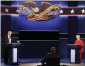  ?? AP PHOTO/DAVID GOLDMAN ?? Republican presidenti­al nominee Donald Trump answers a question as Democratic presidenti­al nominee Hillary Clinton listens during the presidenti­al debate Monday.