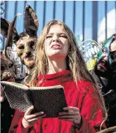  ?? PHOTO: LIAM McBURNEY ?? Demands: Extinction Rebellion activist Lucy Holmes from Mullingar reads her poem, ‘Silence’, to protesters outside Government Buildings as Budget 2020 was delivered to the Dáil.