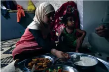  ?? — AFP ?? Umm Samer’s family, displaced from eastern Ghouta, gather to break their fast at their home in Maarrat Misrin some seven kilometres north of Idlib