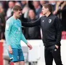  ??  ?? Chris Mepham with Bournemout­h interim manager Jonathan Woodgate after his red card against Brentford.
