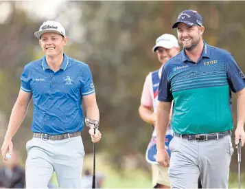  ?? AFP ?? Cameron Smith, left, and Marc Leishmann of Australia share a light moment on the first day of the World Cup of Golf in Melbourne.