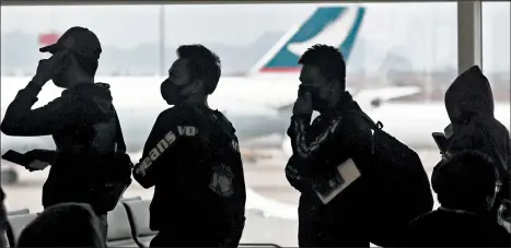  ?? ACHMAD IBRAHIM/AP ?? People line up for departure Feb. 4 at Hong Kong’s airport. The United States’ program to screen travelers ran into data problems and “bad informatio­n.”