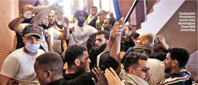  ??  ?? Flashpoint: Protesters storm into Kensington Town Hall yesterday