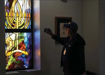  ?? LM OTERO — THE ASSOCIATED PRESS ?? A stained glass window that once had bullet holes is now repaired at Congregati­on Beth Israel in Colleyvill­e, Texas in April.