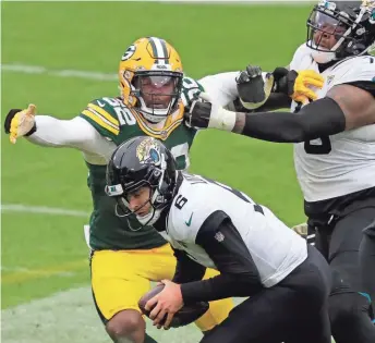  ?? DAN POWERS / USAT ?? Rashan Gary picks up a crucial sack of Jaguars quarterbac­k Jake Luton late in the fourth quarter with the Packers protecting a four-point lead.