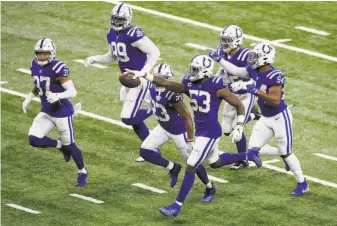  ?? Andy Lyons / Getty Images ?? Colts linebacker Darius Leonard ( 53) celebrates a fumble recovery. After allowing 28 points in the first half, the Indianapol­is defense held Green Bay to three points in the second half.