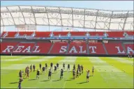  ?? Rick Bowmer / Associated Press ?? Members of the U.S. Women’s National team warm up during a 2014 practice at Rio Tinto Stadium in Sandy, Utah. Pro soccer returns to the U.S. next month when the National Women's Soccer League starts a 25-game tournament in a pair of stadiums in Utah.