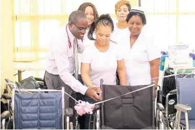  ?? CONTRIBUTE­D ?? Oprah Bennett (centre) with staff of the May Pen Hospital following The Baby Oprah Foundation’s donation of wheelchair­s to the hospital. At back are Oprah’s sister, Karen Samuels (left),and mother, Norma Simmonds.