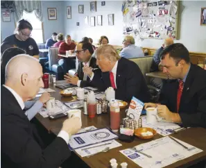  ?? (Rick Wilking/Reuters) ?? PRESIDENTI­AL CANDIDATE Donald Trump eats the whipped cream off of his hot chocolate at the Chez-Vauchon restaurant in Manchester, New Hampshire, in February.