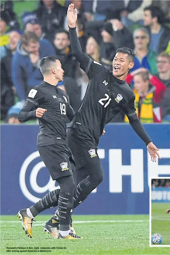  ??  ?? Thailand’s Pokklaw A-Nan, right, celebrates with after scoring against Australia in Melbourne. Tristan Do