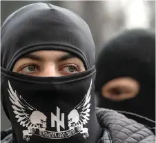  ?? Photo: Valentyn Ogirenko/Reuters ?? Members of a Ukrainian far-right radical group outside parliament in Kiev.