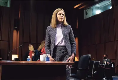  ?? Stefani Reynolds / Associated Press ?? Supreme Court nominee Amy Coney Barrett departs during a break in a confirmati­on hearing before the Senate Judiciary Committee in Washington on Wednesday.