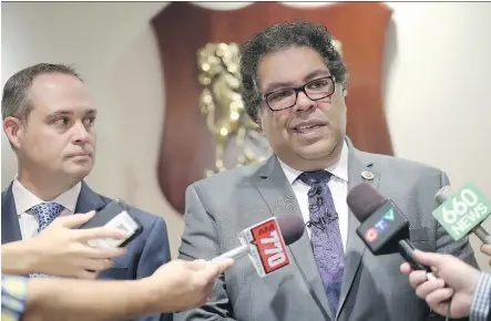  ?? LEAH HENNEL ?? Mayor Naheed Nenshi and Dean Koeller, left, who chaired a committee to raise the funds, announce the completion of a campaign to cover the cost of legal fees for the mayor’s defence in a lawsuit settled in 2016. The drive raised almost $300,000 from...