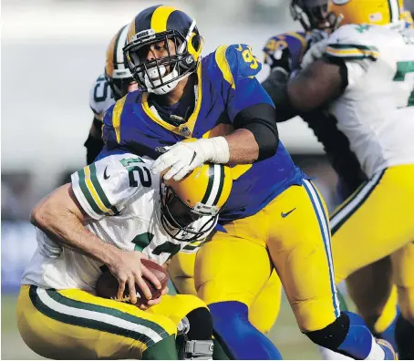  ?? MARCIO JOSE SANCHEZ/THE ASSOCIATED PRESS ?? Rams defensive tackle Aaron Donald sacks Green Bay Packers quarterbac­k Aaron Rodgers during Sunday’s back-and-forth game in Los Angeles that saw the Rams remain undefeated and improve to 8-0 on the season with a 29-27 victory.