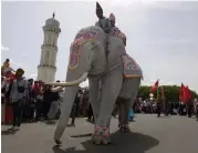  ?? — AFP ?? Traditiona­lly- dressed participan­ts ( above) riding on a white elephant during a cultural parade in Banda Aceh, Indonesia, on Monday.