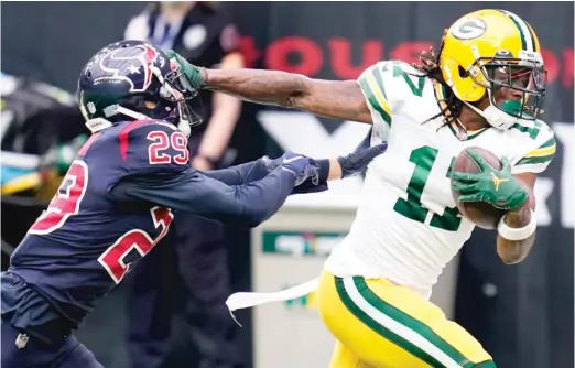  ?? SAM CRAFT/AP ?? Packers wide receiver Davante Adams, stiff-arming Texans cornerback Phillip Gaines, had 13 receptions for 196 yards and two touchdowns.