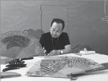  ?? PHOTOS BY CAO CHEN / CHINA DAILY ?? Left: Xing Weizhong, a craftsman of sandalwood fans, with their subtle fragrance, demonstrat­es his skills at the Baoshan Internatio­nal Folk Arts Exposition in Shanghai.