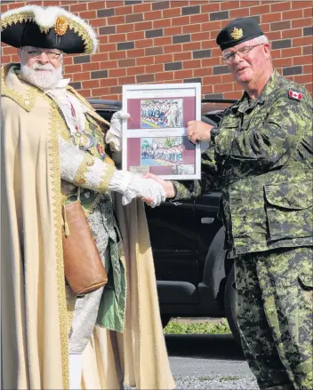  ?? COLIN MACKENZIE ?? Windsor town crier Lloyd Smith presented a proclamati­on and a framed picture to Capt. Keith Hynes, the commanding officer of the Kings-Edgehill School 254 Cadet Corps.