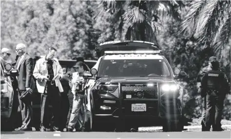  ?? LEONARD ORTIZ/THE ORANGE COUNTY REGISTER VIA AP ?? Investigat­ors gather outside the Geneva Presbyteri­an Church in Laguna Woods, Calif., on Sunday after a fatal shooting.