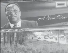  ?? AP PHOTO ?? Traffic flows past a billboard with a portrait of Emmerson Mnangagwa, the new Zimbabwean president, in Harare, Zimbabwe. Zimbabwe’s security forces said in a joint statement Monday that the “situation in our country had returned to normalcy” after a...