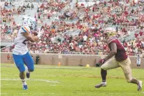  ?? MARK WALLHEISER/ASSOCIATED PRESS ?? Boise State wide receiver Khyheem Waleed, left, makes a catch in front of Florida State defensive back Jaiden Lars-Woodbey during Saturday’s game in Tallahasse­e, Fla. Boise State defeated Florida State, 36-31.