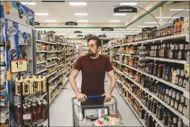  ?? GEORGE ETHEREDGE / THE NEW YORK TIMES ?? Tony Hovater, a welder and white-nationalis­t organizer, shops for groceries in Huber Heights in August. Wright State University political science professor Lee Hannah said the article about Hovater exposes his “naive and uninformed views” but that...