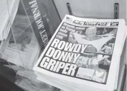  ?? Richard Drew, The Associated Press ?? Copies of the New York Post with an illustrati­on of President Donald Trump as a profession­al wrestler on the front page are displayed at a newsstand in New York City last Monday. On Sunday, Trump tweeted a mock video that showed him pummeling a man in a business suit with his face obscured by the CNN logo.