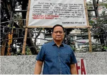  ?? PHOTO: REUTERS ?? Philipino Mayor Ike Ponce poses in front of a banner denouncing the Bonnet Gang, outside the municipal hall in the Philippine town of Pateros, Metro Manila.