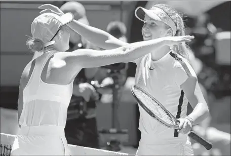  ?? Dita Alangkara Associated Press ?? ELINA SVITOLINA, right, embraces 15-year-old Marta Kostyuk after defeating her in a third-round match at the Australila­n Open. “She’s a great fighter,” Svitolina said after the match. “She has a great future — we’re going to hear a lot more about her.”