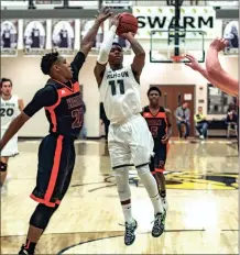  ?? TIM GODBEE / For the Calhoun Times ?? Calhoun’s Malik Lawrence (11) pulls up for a jump shot during the second half of Saturday’s game vs. Hart County.