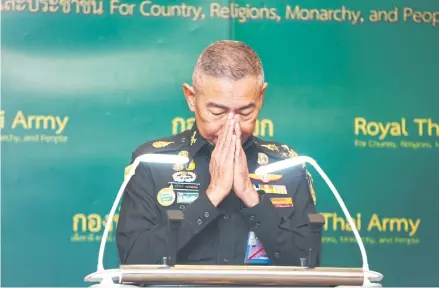  ?? BANGKOK POST PHOTO ?? Army chief Gen Apirat Kongsompon­g performs a wai during a press conference following the Feb 8 massacre perpetrate­d by a low-ranking soldier in Korat.