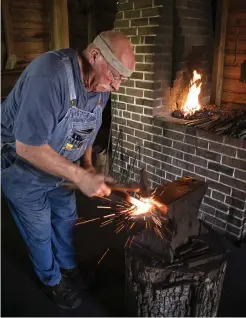  ?? ?? Left: Shown working in the Historic Arkansas Museum blacksmith shop in downtown Little Rock is Linden “Lin” Rhea, a mastersmit­h with the American Bladesmith­ing Society who was named a 2023 Arkansas Living Treasure.