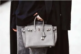  ?? Edward Berthelot/Getty Images 2023 ?? Birkin luxury handbags are handcrafte­d by artisans in France. A lawsuit describes them as “icons of fashion.” In-store prices range from thousands of dollars to $100,000, the suit said.