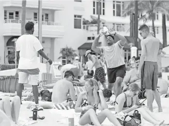  ?? AMY BETH BENNETT/SOUTH FLORIDA SUN SENTINEL ?? Spring breakers relax on Fort Lauderdale beach on Monday.