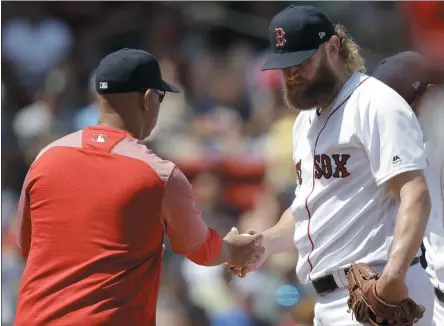  ?? STEVEN SENNE - THE ASSOCIATED PRESS ?? Boston Red Sox’s Andrew Cashner, right, hands the ball to manager Alex Cora, left, as he is retired from a baseball game in the second inning against the Los Angeles Angels at Fenway Park, Sunday, Aug. 11, 2019, in Boston.