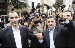  ?? — AP ?? TEHRAN: Former Iranian President Mahmoud Ahmadineja­d (right) and his close ally Hamid Baghaei flash the victory sign yesterday as they arrive at the Interior Ministry to register their candidacy for the upcoming presidenti­al elections.