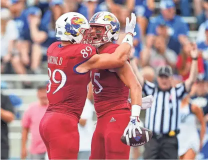  ?? JAY BIGGERSTAF­F/USA TODAY SPORTS ?? Kansas football tight end Trevor Kardell (45) celebrates with tight end Mason Fairchild (89) after scoring a touchdown during the first half of a game against BYU on Sept. 23 in Lawrence.