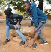  ?? TSVANGIRAY­I MUKWAZHI/AP ?? As a toes-for-cash hoax flourished, street vendors remove their shoes to show their toes Thursday in the Zimbabwean capital city of Harare.