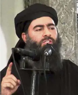  ??  ?? Face of terror: Baghdadi delivering a sermon during his first public appearance at the al-Nuri mosque in Mosul. — AP