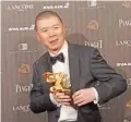  ??  ?? Chinese director Feng Xiaogang holds his award for Best Director at the 53rd Golden Horse Awards in Taipei, Taiwan.