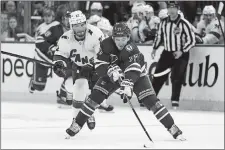  ?? JOHN MINCHILLO/AP PHOTO ?? New York Rangers center Frank Vatrano (77) breaks away from Carolina Hurricanes defenseman Brett Pesce (22) in the second period of Game 4 of an NHL Stanley Cup second-round playoff series on Tuesday night in New York.