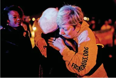  ?? [PHOTOS BY SARAH PHIPPS, THE OKLAHOMAN] ?? Sara Cunningham hugs Vivian Stevens during a Transgende­r Day of Remembranc­e.