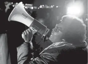  ?? CHRIS DAY / THE JACKSON SUN ?? Amber Sherman speaks into a megaphone as demonstrat­ors block traffic on I-55 at the Memphis-arkansas Bridge as they protest the killing of Tyre Nichols on Friday, Jan. 27, 2023, in Memphis, Tenn.