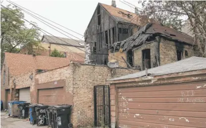  ?? ASHLEE REZIN/SUN-TIMES FILE ?? The city alleges violations in the front building and the rear coach house of the burned building at 2224 S. Sacramento, including missing or defective smoke and carbon monoxide detectors and junk and debris obstructin­g exits.