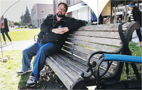  ?? DAN JANISSE ?? Ron Dunn, executive director of the Downtown Mission, takes a seat in front of the Wellness Centre on Ouellette Avenue. For the second consecutiv­e year Dunn will sit on the bench for 24 hours and talk to people about homelessne­ss, poverty, addiction and mental-health issues.