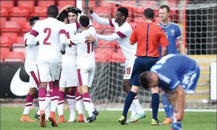  ??  ?? Friendly fire: Scotland’s opponents Qatar celebrate equalising in Sunday’s 1-1 draw against Northern Ireland