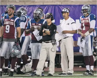  ?? THE CANADIAN PRESS/ FILES ?? Alouettes general manager and head coach Jim Popp, centre, and quarterbac­ks coach Anthony Calvillo, right, have much to do to improve the club’s offence in the off- season.